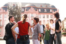 Eine Stadtführerin erläutert einer Touristengruppe den Fastnachtsbrunnen.